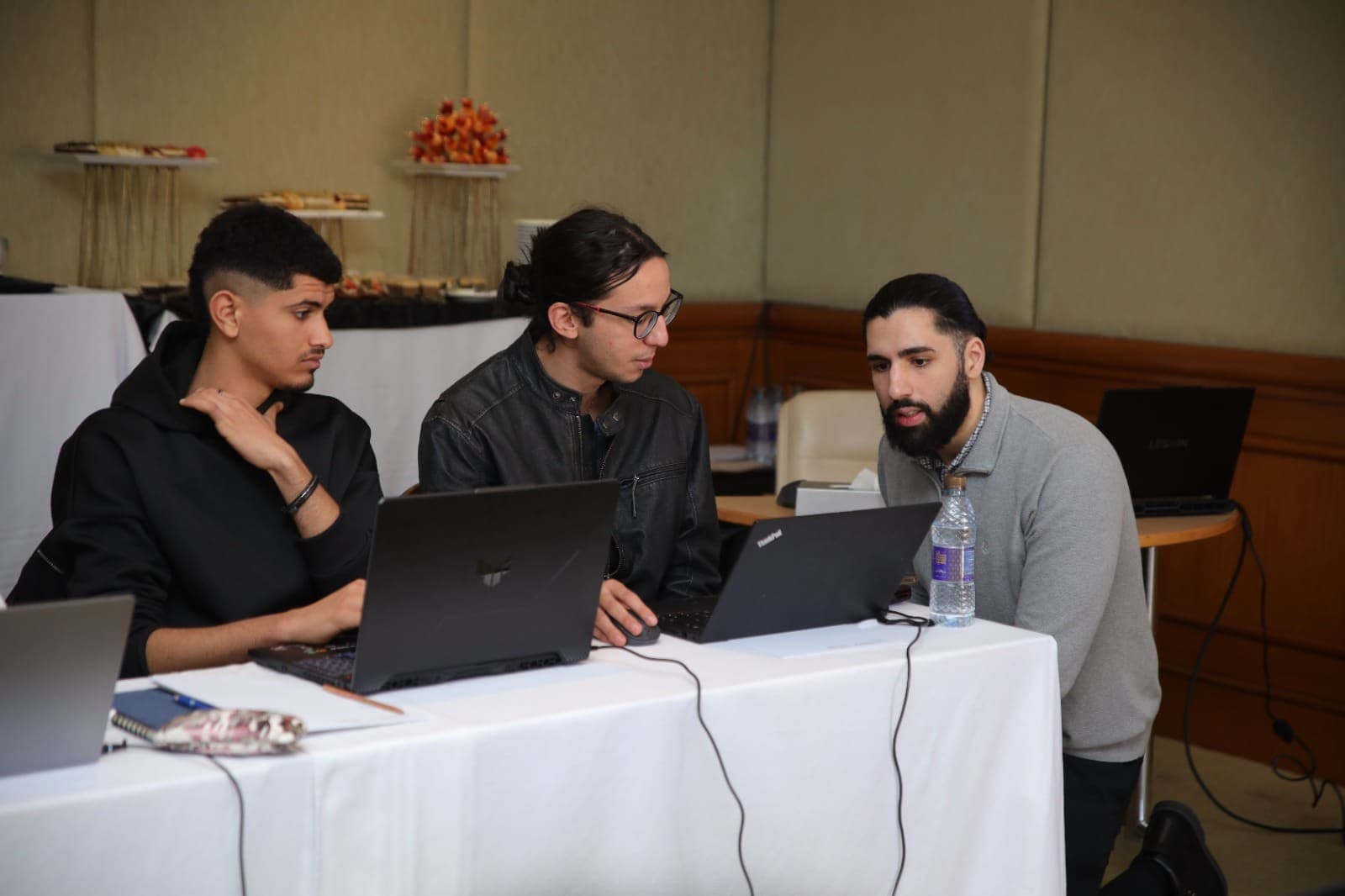 Howdang Rashid delivering a hands-on workshop, helping attendees at their laptops
